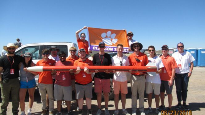 Members of the Clemson Rocketry Team hold their creation at the 2018 Intercollegiate Rocket Engineering Competition.