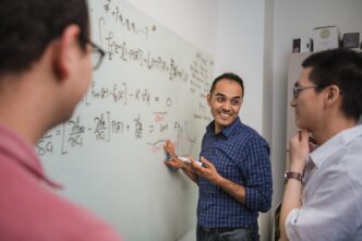 Fadi Abdeljawad (center) talks with graduate students Maher Alghalayin (left) and Hyunsoo Lee in Abdeljawad's office.