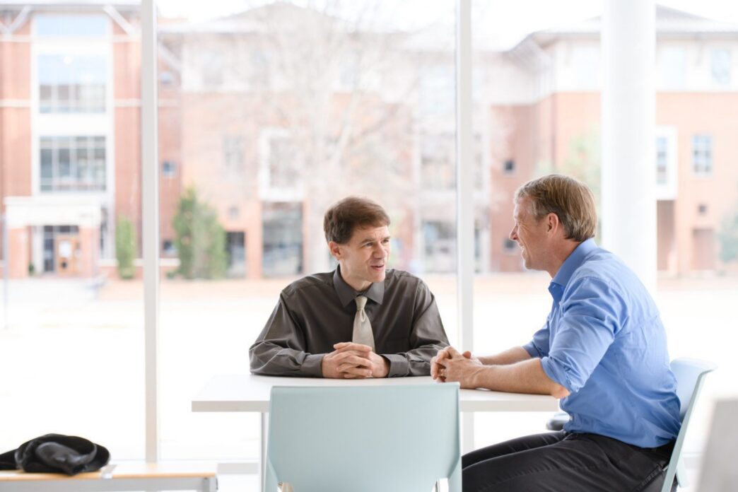 Cole Smith, left, and Laine Mears meet in the Watt Family Innovation Center to talk about the graduate programs they are overseeing and were made possible by the National Science Foundation Research Traineeship Program.
