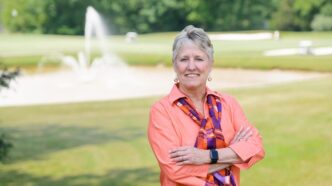 Melinda Chappell stands outside Madren Center, overlooking the Walker Golf Course