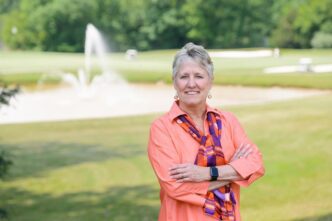 Melinda Chappell stands outside Madren Center, overlooking the Walker Golf Course