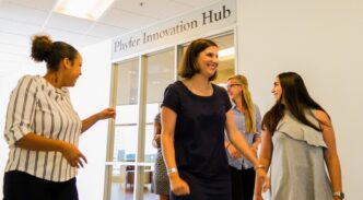 Students mingling outside entrance to Phyfer Innovation Hub