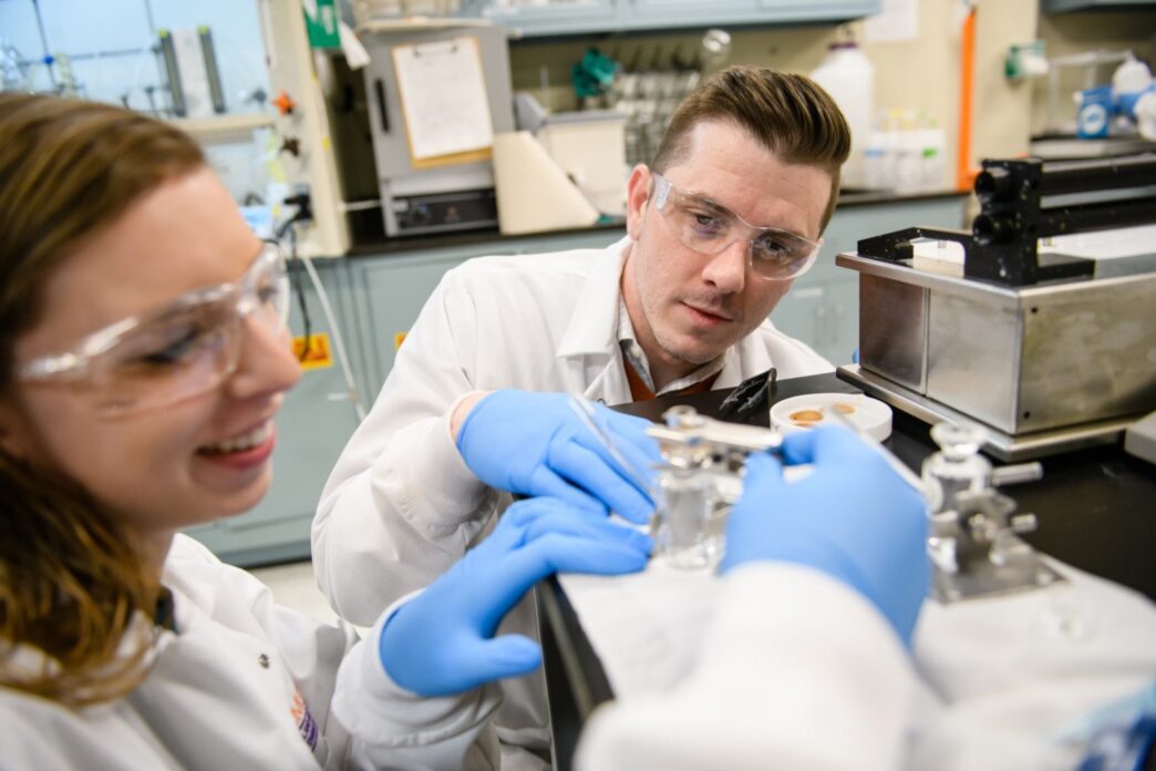 Eric Davis, right, works with a student in Clemson University's Earle Hall.