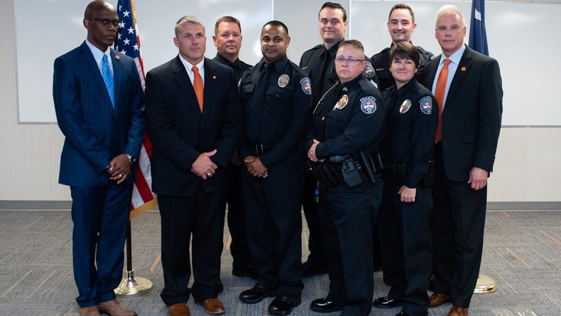 Associate Vice President for Public Safety and Chief of Police Greg Mullen (right) joins the newest group of officers announced among his department in July 2019.