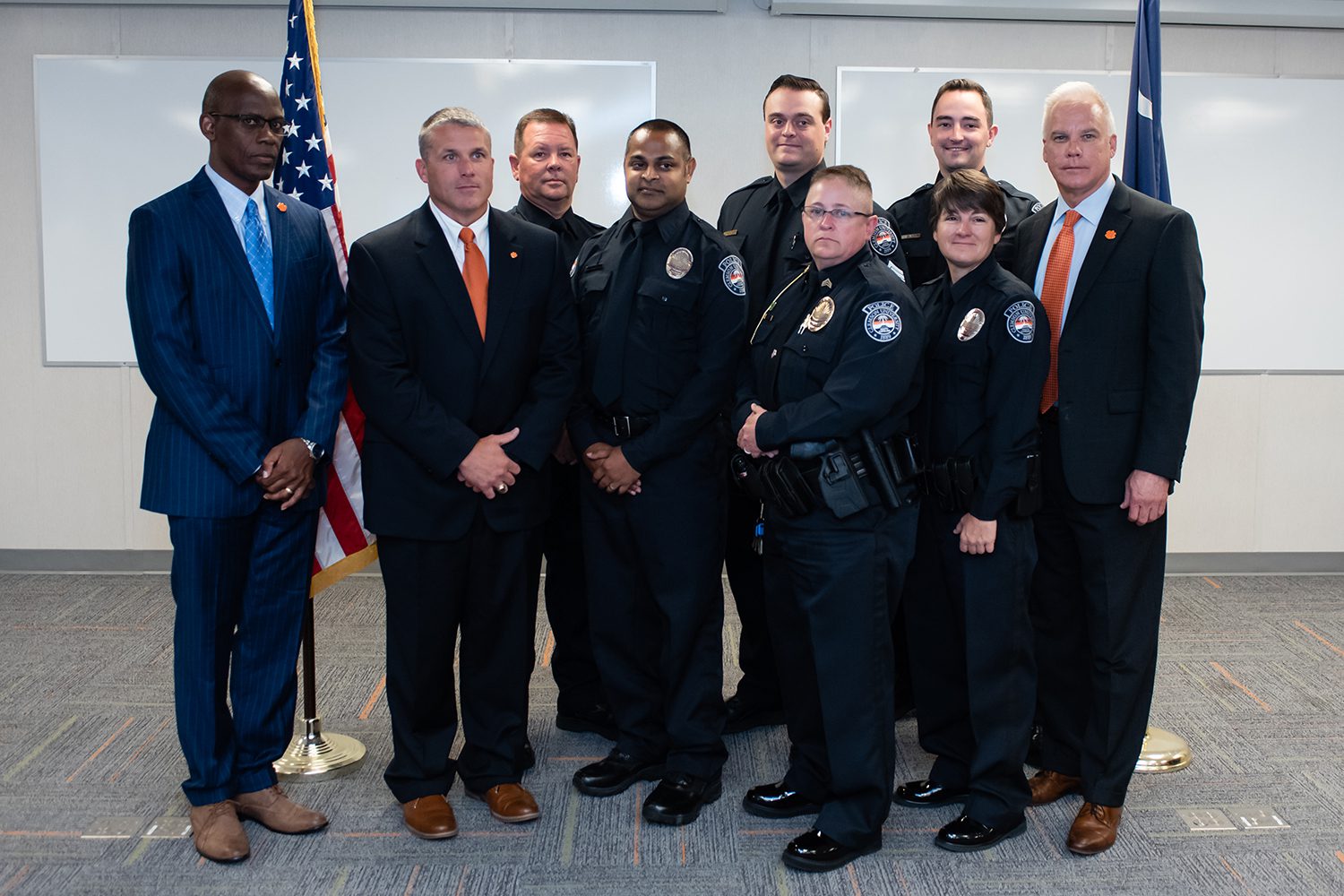 Associate Vice President for Public Safety and Chief of Police Greg Mullen (right) joins the newest group of officers announced among his department in July 2019.