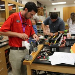 Cliff Collins of Heard County HS in Roopville, Georgia builds a single pole switch circuit during the 2019 Clemson STEM it UP conference.