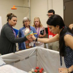 Melissa Munoz, a Clemson doctoral student, talks about storing roses in a humid chamber as part of a Botrytis study she is working on with Clemson horticulture professor Jim Faust during the 2019 STEM it UP! conference at Clemson University.