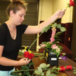Jenny Allen of Newton HS in Newton, NJ creates a floral arrangement during the Introduction to Floral Design Techniques session of the 2019 STEM it UP! conference at Clemson University.