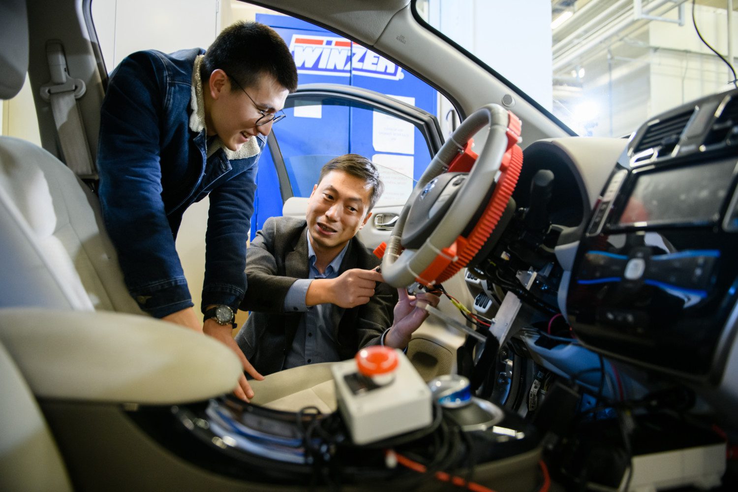 Yunyi Jia, right, works with a student at the Clemson University International Center for Automotive Research.