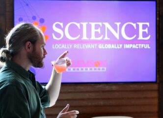 College of Science Professor listens to dean talk at faculty meeting.