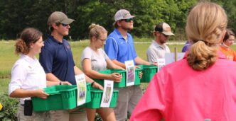 Attendees participate in cultivar field trial demonstration.