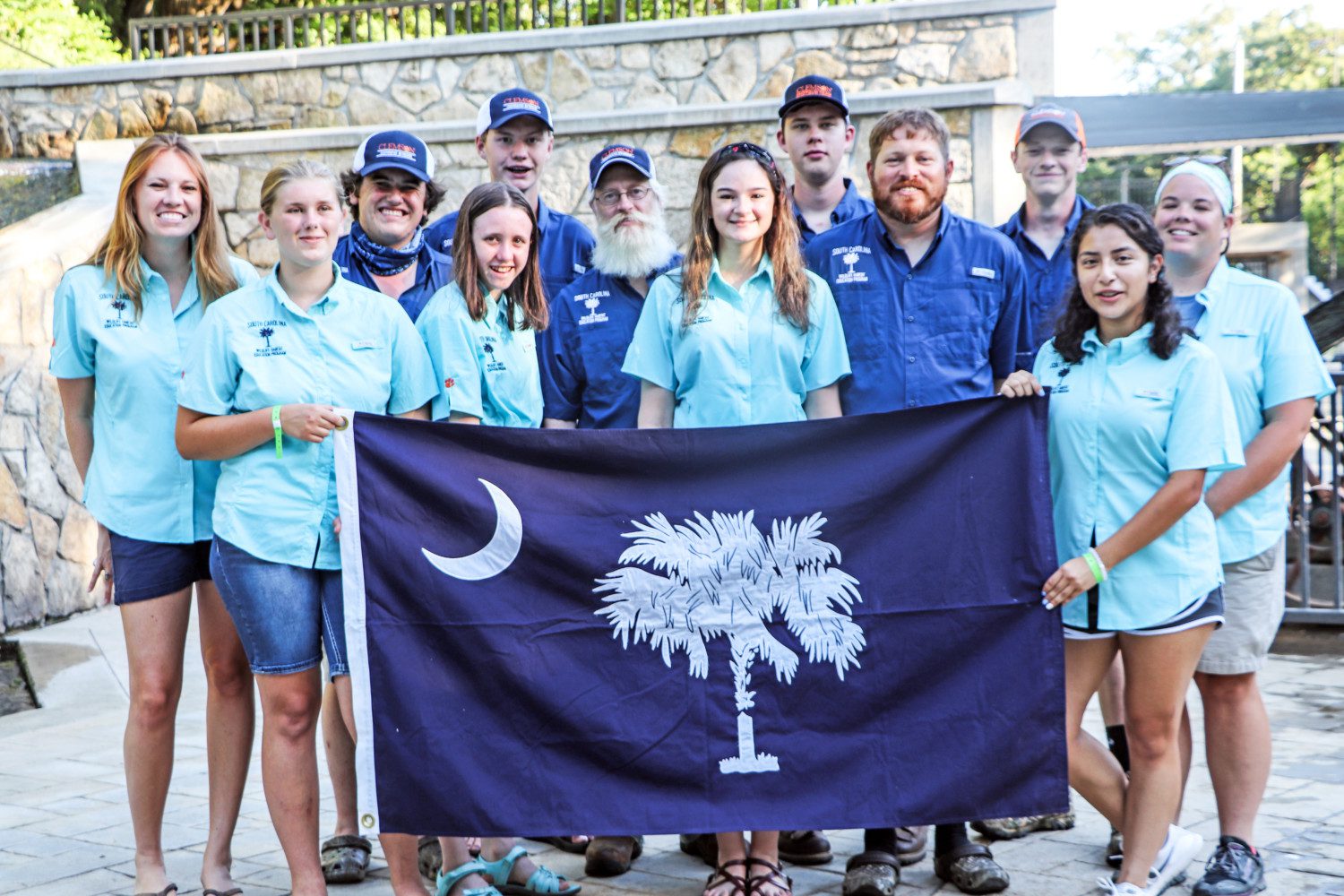 4-H and FFA teams pose together with South Carolina state flag at WHEP competition.