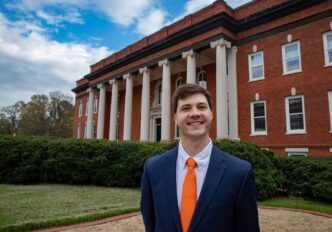 Graduate student government president Miles Maynard in front of Sikes Hall in 2019