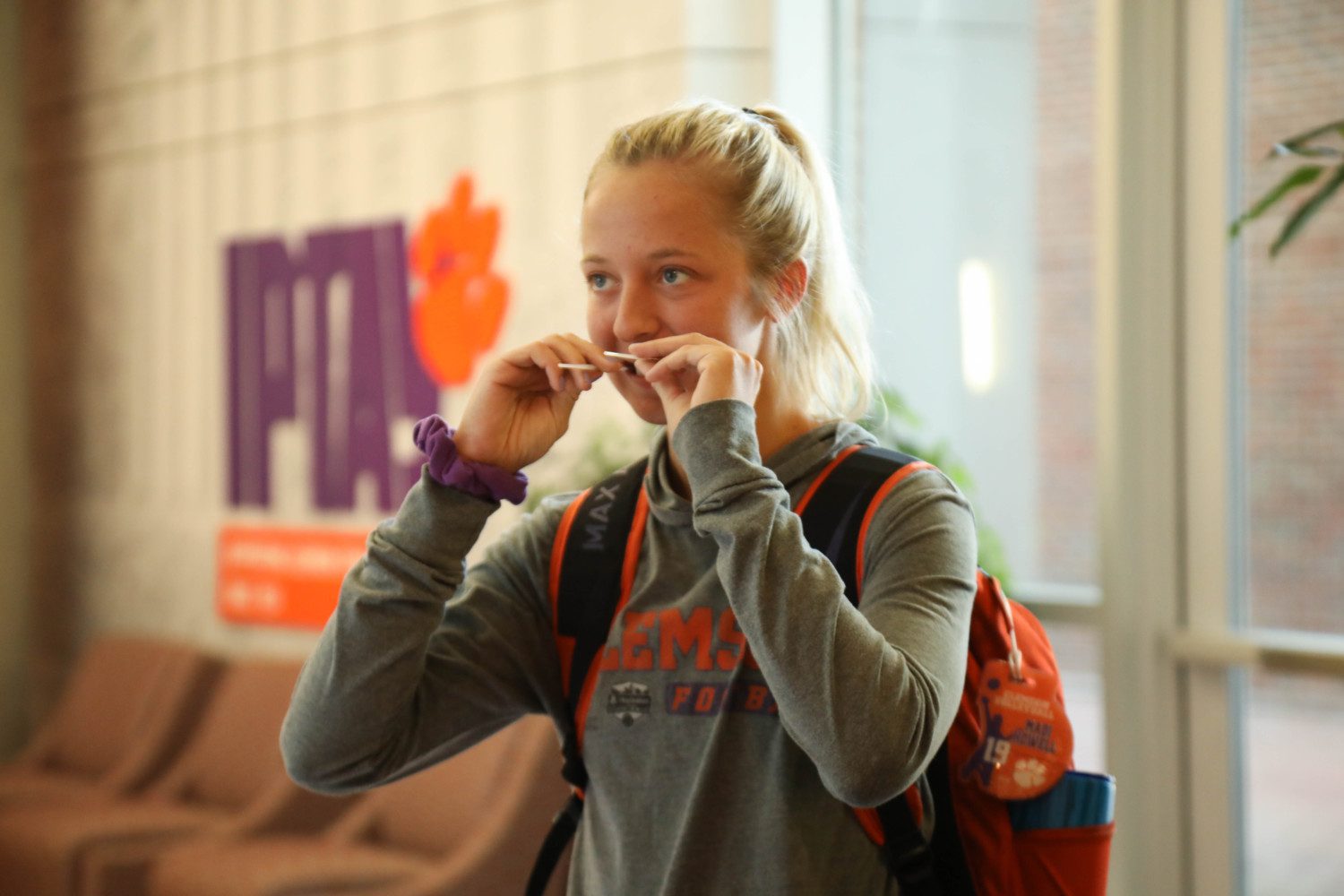 Madi Howell of Clemson volleyball swabbing her cheeks to be added to the Project Life global bone marrow registry