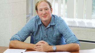 Professor Ben Jaye sitting at his desk