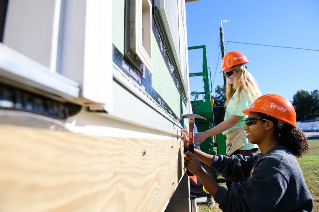 Photo of student volunteers working on last year's Habitat for Humanity Homecoming house.