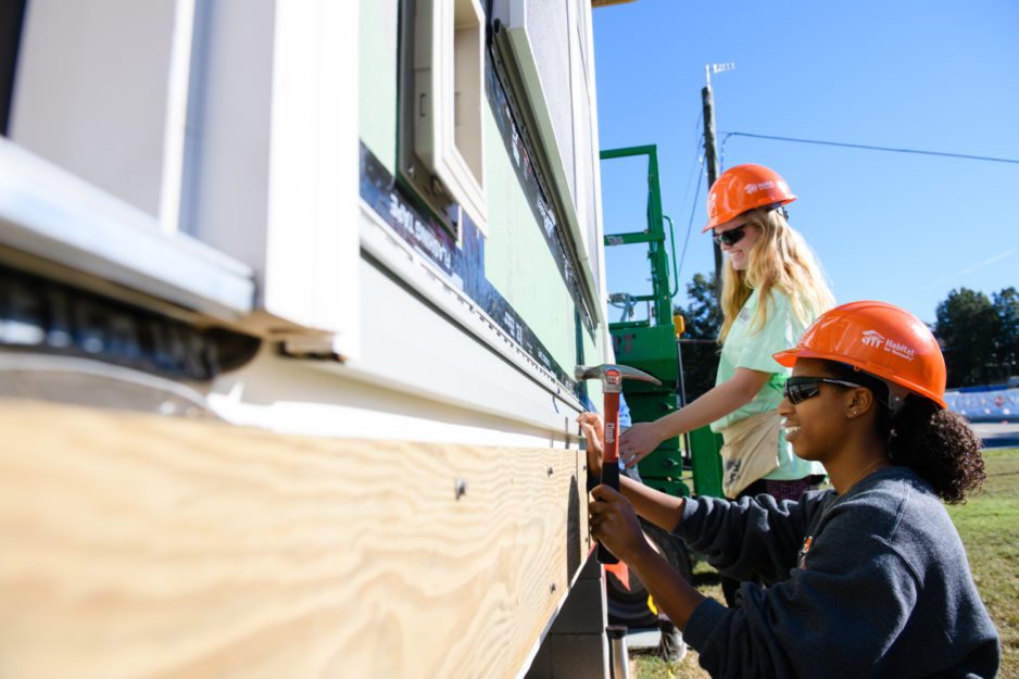 Photo of student volunteers working on last year's Habitat for Humanity Homecoming house.