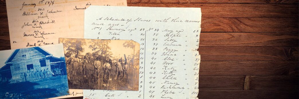 Historic documents and images are spread out on a table.
