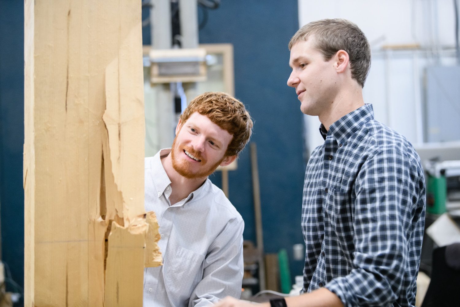 Graham Montgomery, left, and Michael Stoner examine a piece of wood that was put to the test in research at Clemson University.