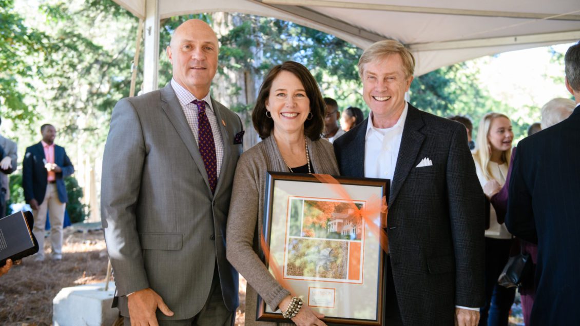 Clemson President James P. Clements presents a framed leaf to Becky and Courts Cooledge, daughter and son-in-law of Jerry and Harriett Dempsey, at the Legacy Day Bronze Leaf ceremony.