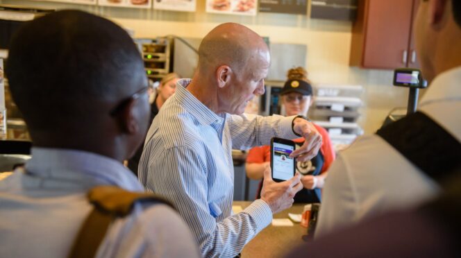 Steve Robbins of TigerOne Card Services demonstrates a transaction using mobile ID at a retail dining location in Hendrix Student Center.