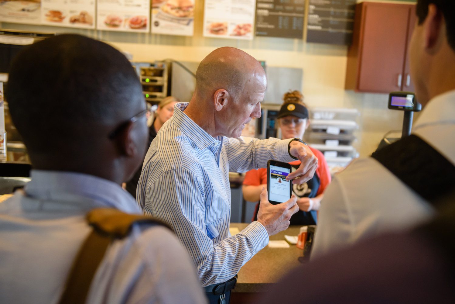 Steve Robbins of TigerOne Card Services demonstrates a transaction using mobile ID at a retail dining location in Hendrix Student Center.