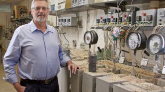 Chemistry professor Kolis standing in lab