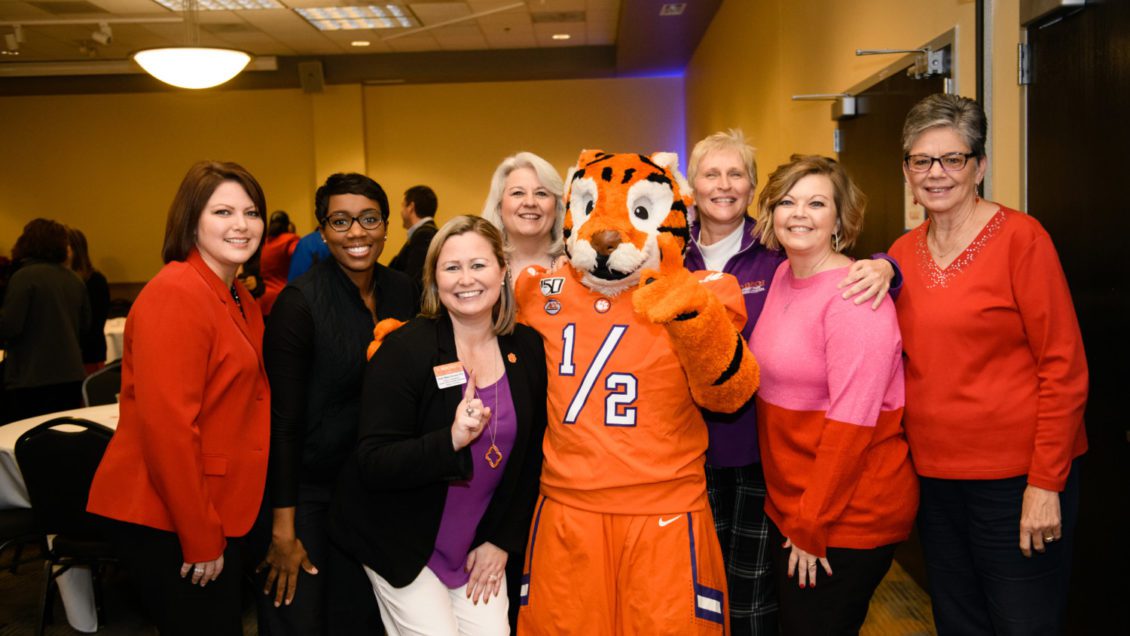 Members of the Student Affairs Business Office pose with the Tiger Cub at the division's winter social on Dec. 4, 2019