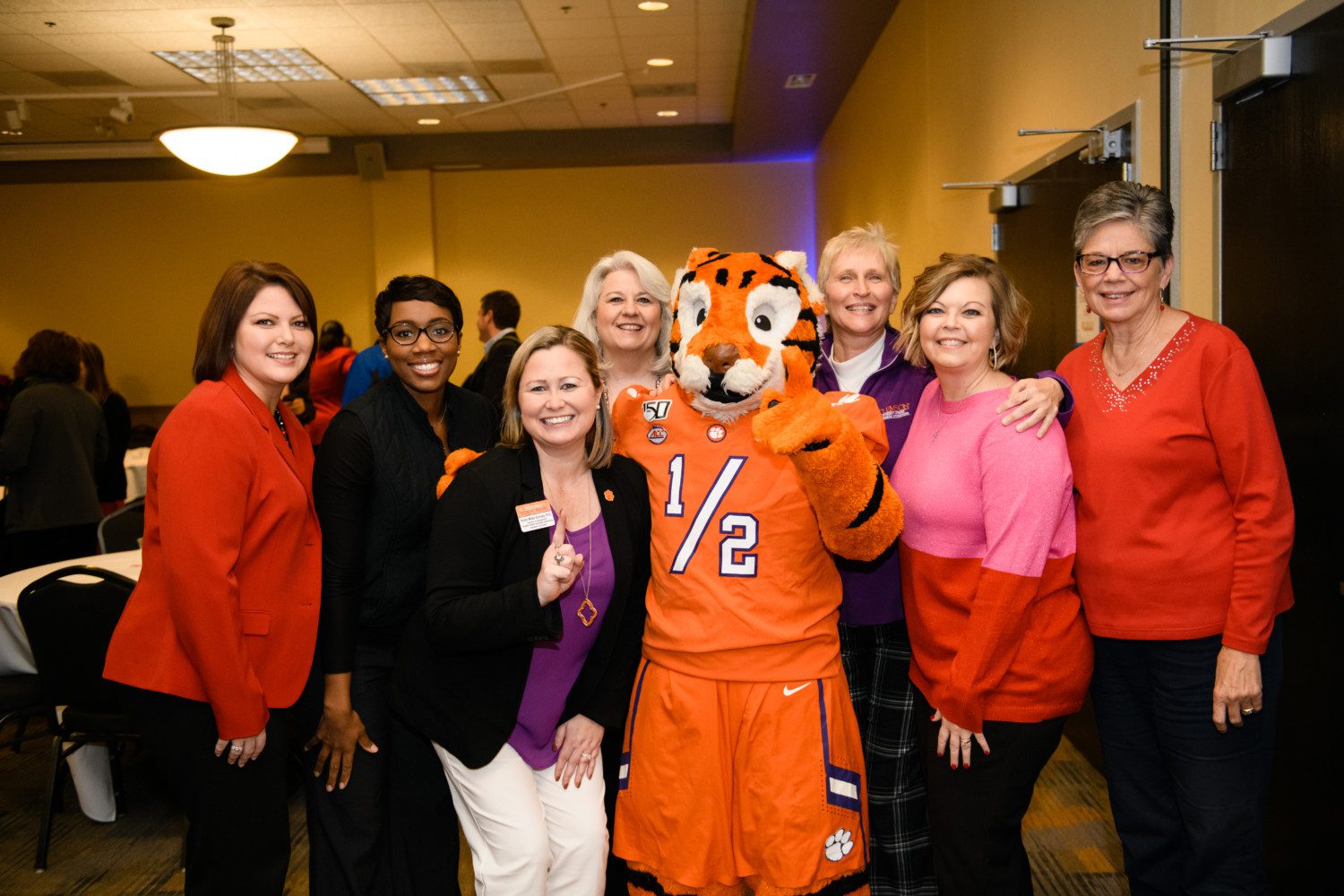 Members of the Student Affairs Business Office pose with the Tiger Cub at the division's winter social on Dec. 4, 2019