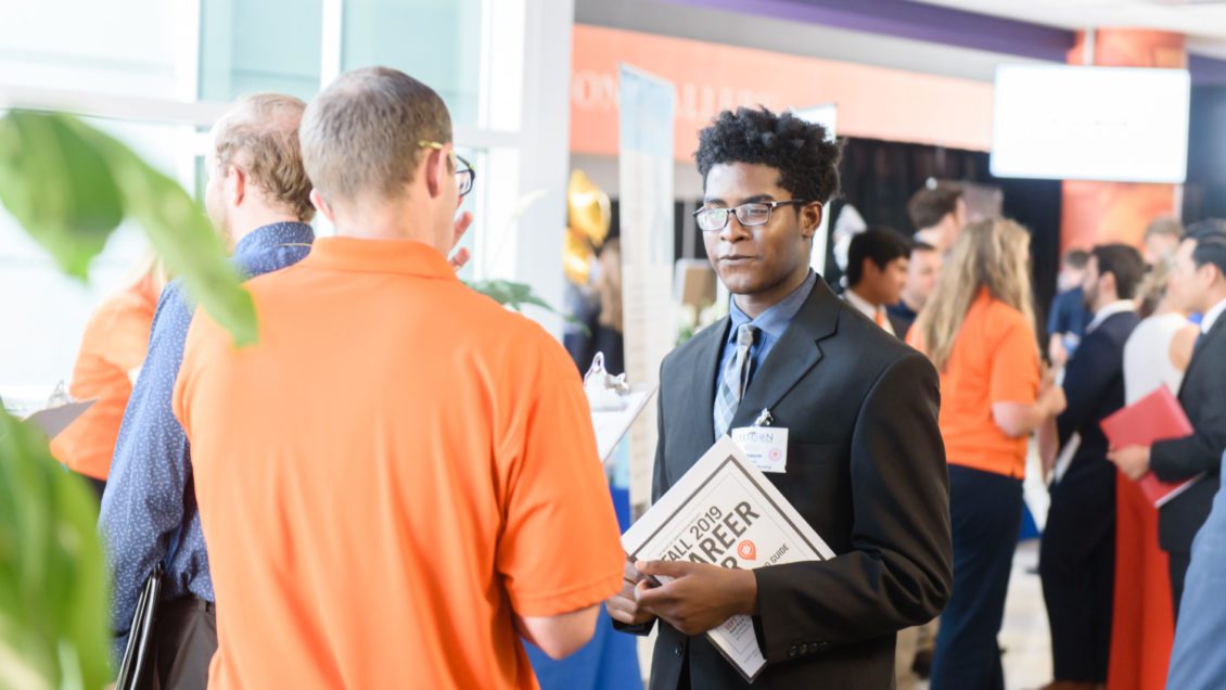 A student meets with a prospective employer in Littlejohn Coliseum during the 2019 Fall Career Fair.