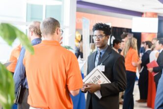 A student meets with a prospective employer in Littlejohn Coliseum during the 2019 Fall Career Fair.