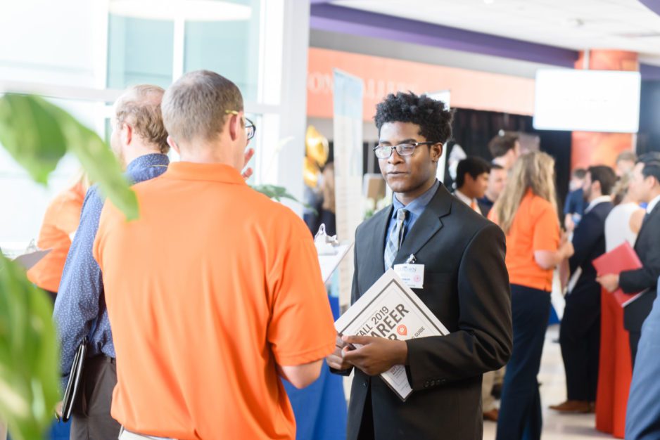 A student meets with a prospective employer in Littlejohn Coliseum during the 2019 Fall Career Fair.