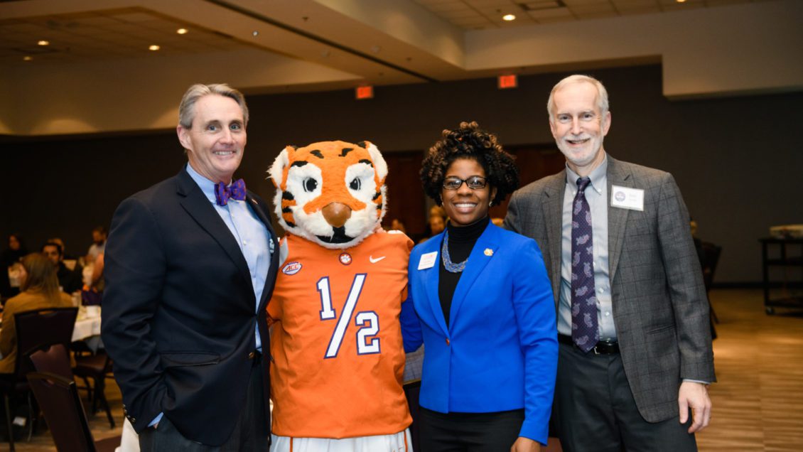Provost Bob Jones takes a picture with the Tiger mascot and two Clemson employees.