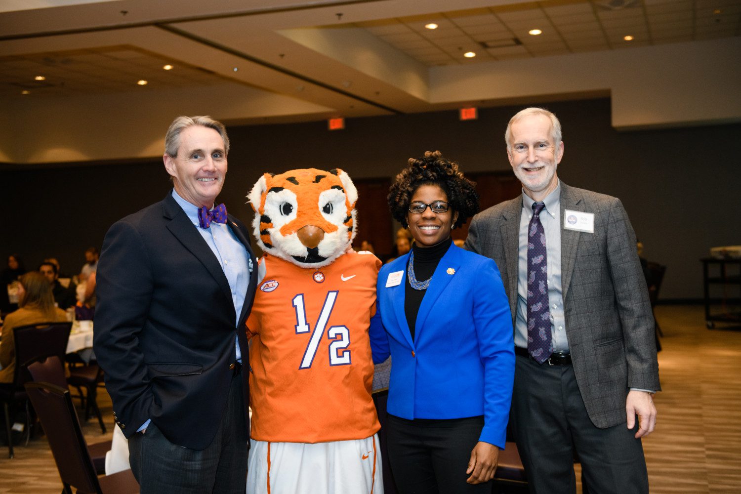 Provost Bob Jones takes a picture with the Tiger mascot and two Clemson employees.