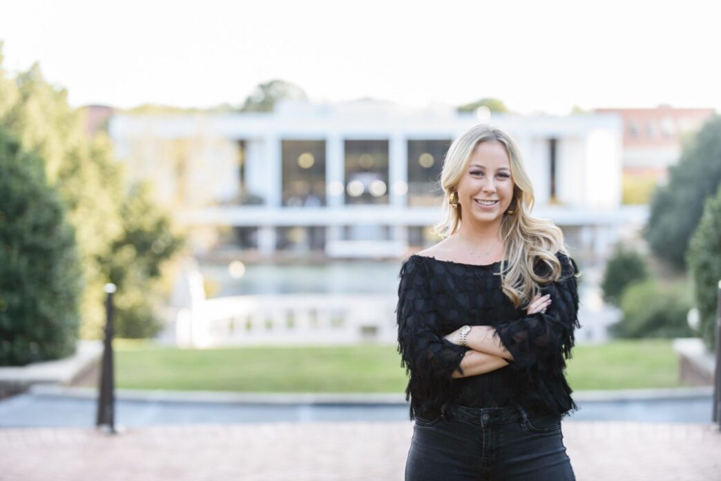 Madison Bolick, a construction science and management major from the class of 2020, in front of Cooper Library and the amphitheater.