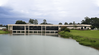 A building sits adjacent to a body of water.