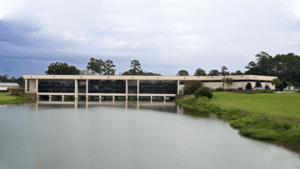 A building sits adjacent to a body of water.