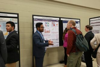 Zolian Zoong Lwe presenting his research to visitors at the international crop science meeting.