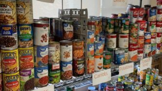 Donated canned goods line the shelves at the pantry.