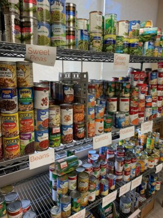 Donated canned goods line the shelves at the pantry.