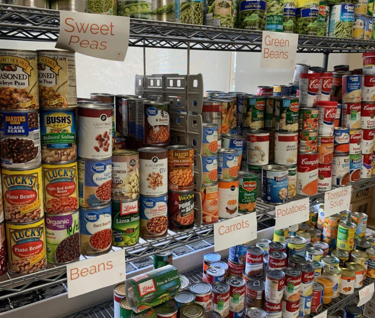 Donated canned goods line the shelves at the pantry.