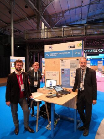 From left: Félix Blanc, Stephanie Lamy and Richard Brooks pose for a photo at the Paris Peace Forum.