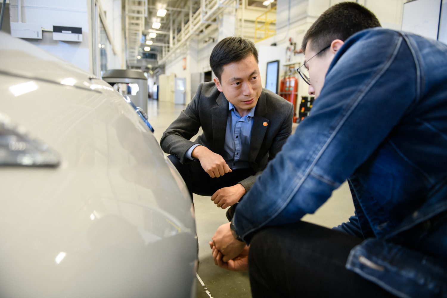 Yunyi Jia (left) works with a graduate student in the Clemson University International Center for Automotive Engineering.
