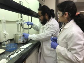 Clemson researchers Sruthi Narayanan and Zoong-Lwe extract lipids in laboratory.