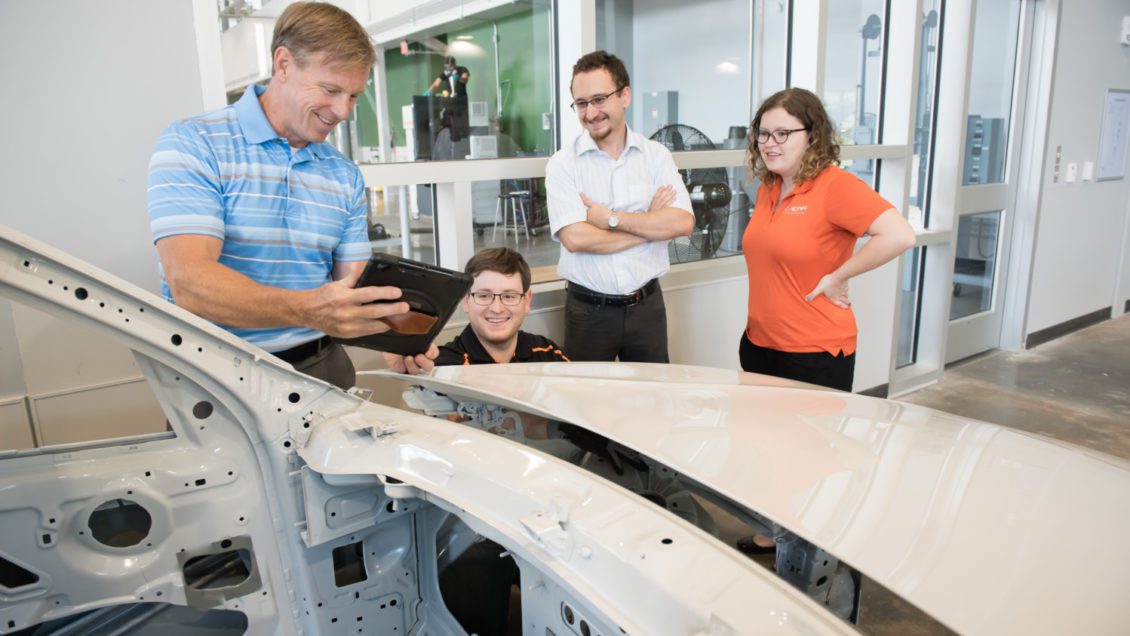 Laine Mears, far left, works with students in the Clemson Vehicle Assembly Center.
