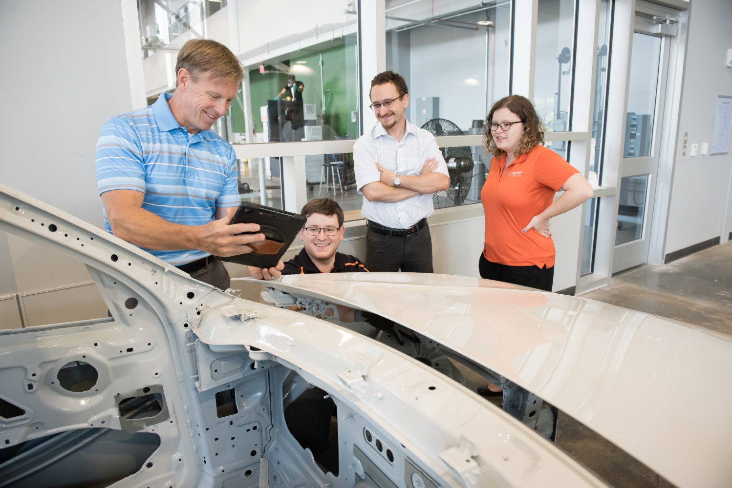 Laine Mears, far left, works with students in the Clemson Vehicle Assembly Center.