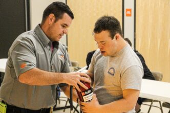 Craig Walters of the Clemson University Fire Department works with ClemsonLIFE students during a fire extinguisher demonstration in Fall 2019.