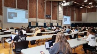 A teacher teaching in a recreation facility during COVID-19.