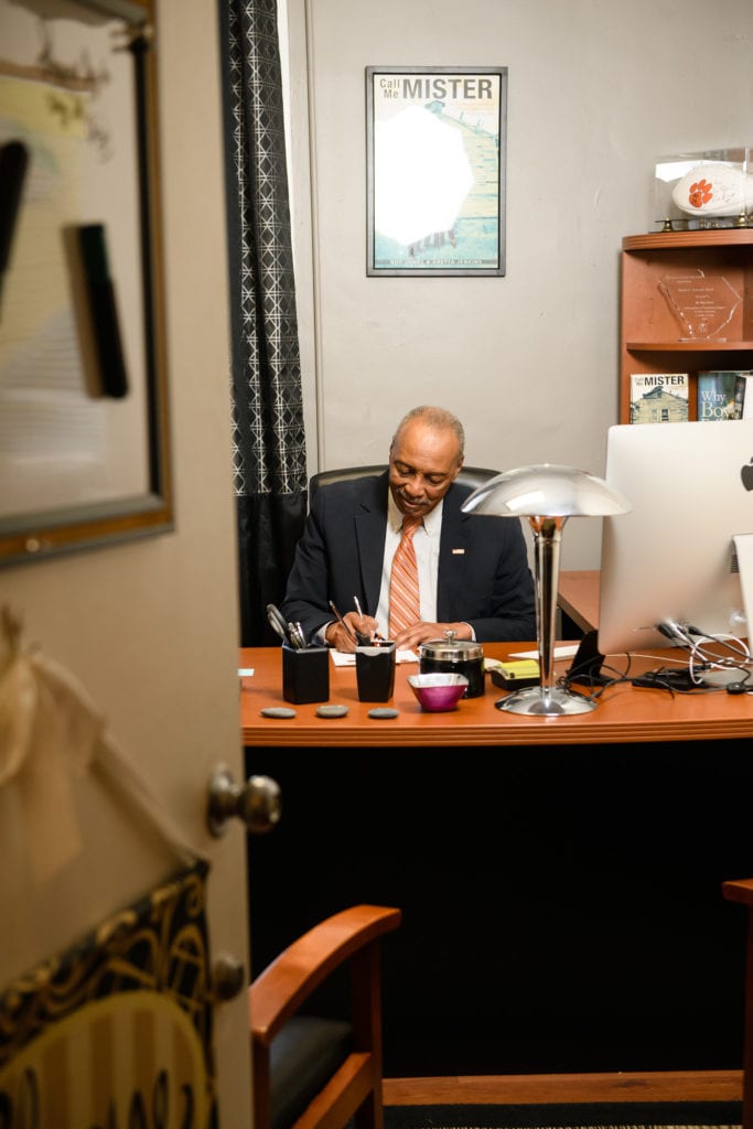 Man seated at a desk working.