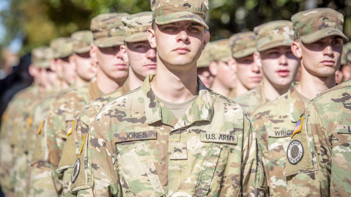 ROTC cadets in Army uniforms stand in formation